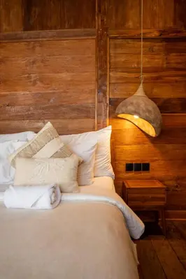 a bedroom with a bed and a pendant light at Tuluscoliving Villa Kuta 3, 3 Bedroom & 3 Bathroom in Ngurah Rai International Airport