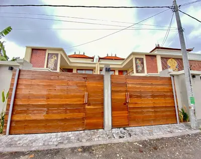 a wooden fence in front of a house at quiet and comfortable villa in sanur kauh in Sanur