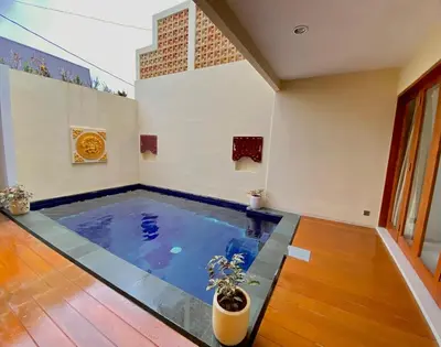 a large indoor swimming pool in a room at quiet and comfortable villa in sanur kauh in Sanur