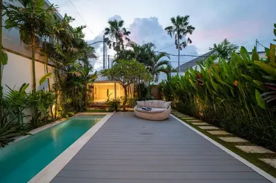 a garden with a pool and a couch next to a house at Luxury 2BR Dharma Villa 5 Private Pool in Canggu in Canggu