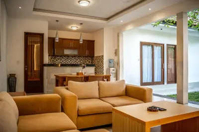 a living room with a couch and a table at Kubu Manggala Villas Seminyak in Seminyak