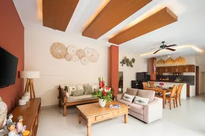 a living room with a couch and a table at Red Lotus Seminyak Villa in Seminyak