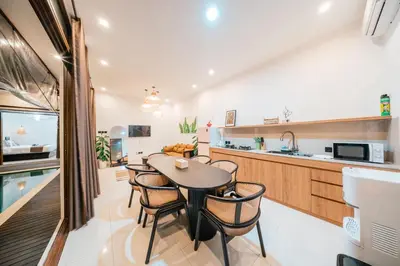 a kitchen and dining room with a table and chairs at Villa Gadang in Kerobokan