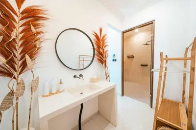 a bathroom with a sink and a mirror at Villa Gadang in Kerobokan