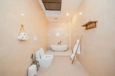 a bathroom with a toilet and a sink at Villa Gadang in Kerobokan
