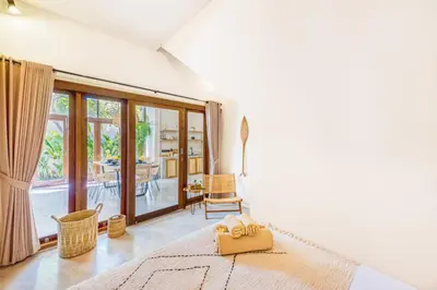 a living room with white walls and a large window at 3BR Villa | Seminyak Central | 450m From Beach in Seminyak