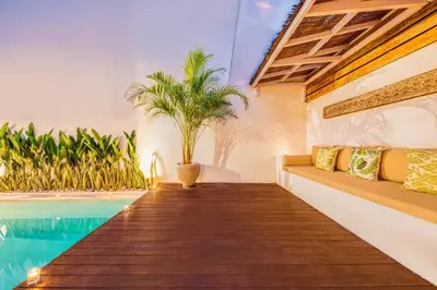a villa with a swimming pool and palm trees at 3BR Villa | Seminyak Central | 450m From Beach in Seminyak