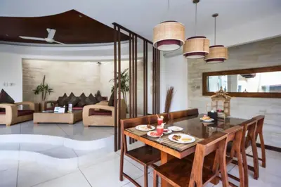 a living room with a wooden table and chairs at Ekavira Peaceful 2 BR Private Pool Villa in Seminyak