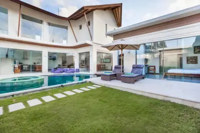a house with a swimming pool and a backyard at Ekavira Peaceful 2 BR Private Pool Villa in Seminyak