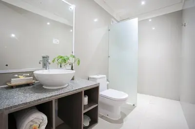 a bathroom with a sink and a toilet at Harmony Beach Suite in Seminyak