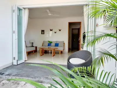 a living room with a couch and a table at Harmony Beach Suite in Seminyak
