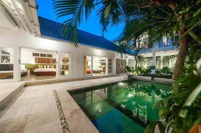 an exterior view of a house with a swimming pool at Tides Seminyak in Seminyak