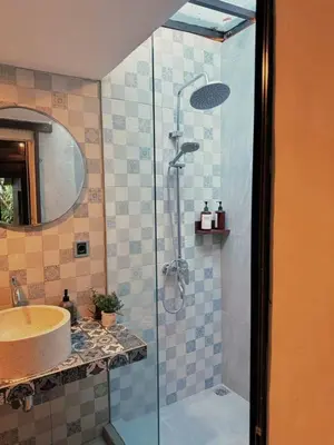 a bathroom with a shower and a sink at Villa Jovino - Jameja By Island Villa Management in Kerobokan