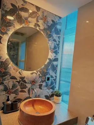 a bathroom with a round sink and a mirror at Villa Jovino - Jameja By Island Villa Management in Kerobokan