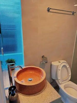 a bathroom with a wooden sink in the middle at Villa Jovino - Jameja By Island Villa Management in Kerobokan