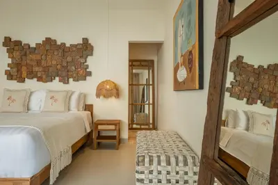 a bedroom with a bed and a mirror at Villa Lediana - 3BR Private pool in Canggu