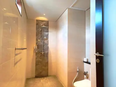 a bathroom with a shower with a toilet and a sink at Tahoma Villas Nakula by ABM in Legian