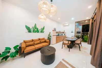 a living room with a couch and a table at Villa Tyaga in Kerobokan