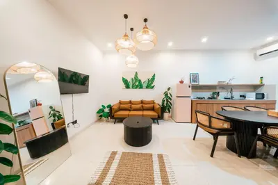 a living room with a table and a couch at Villa Tyaga in Kerobokan