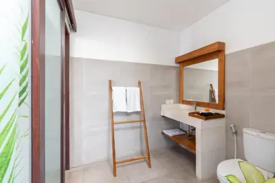 a bathroom with a sink and a mirror at Canggu 3BR Private Pool Villa 3 min to Beach Finns in Canggu