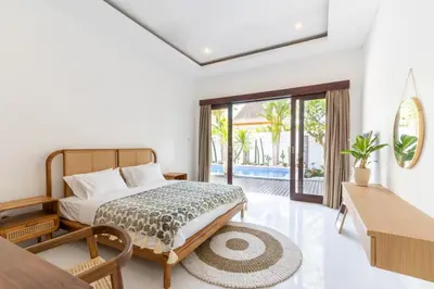 a bedroom with a bed and a view of a pool at Canggu 3BR Private Pool Villa 3 min to Beach Finns in Canggu