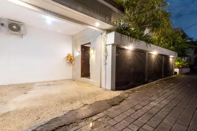 an entrance to a white house with lights on it at Canggu 3BR Private Pool Villa 3 min to Beach Finns in Canggu