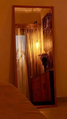 a bedroom with a window with a dresser and a mirror at Villa Marina in Canggu