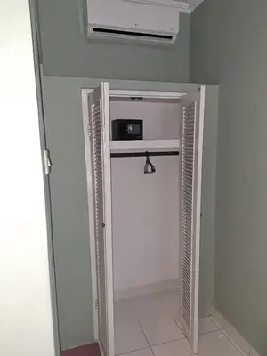 a room with a door open to a room with a heater at Jimmy's Hideaway at Mulia Cottages in Seminyak