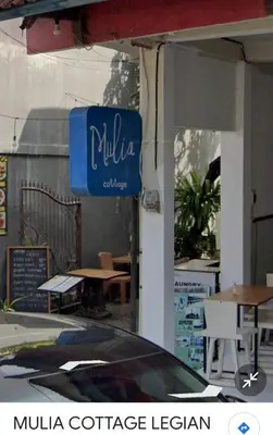 a blue and white sign on the side of a building at Jimmy's Hideaway at Mulia Cottages in Seminyak