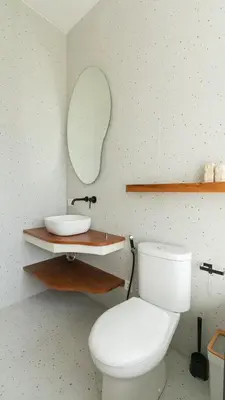 a bathroom with a white toilet and a sink at Casa Amani 3BR Mediterranean w Pool Near Seminyak in Kerobokan