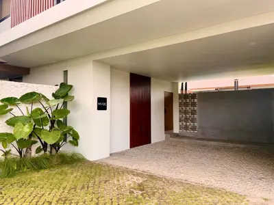 a building with a door and a plant in front of it at Villa Daun Emas in Jimbaran