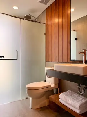 a bathroom with a toilet and a sink and a shower at Villa Daun Emas in Jimbaran