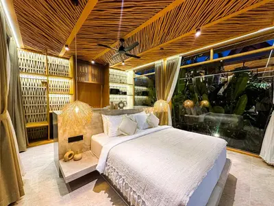 a bedroom with a bed and a large window at Desa Hut - Tropical Haven with Ricefield View near Seminyak in Kerobokan