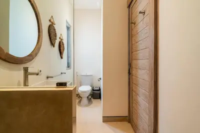 a bathroom with a sink and a toilet and a mirror at NEW Villa Chim Chim Modern 2BR Tropical with Pool in Seminyak