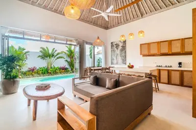 an open living room with a couch and a table at NEW Villa Chim Chim Modern 2BR Tropical with Pool in Seminyak