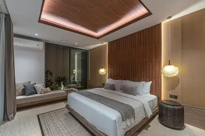 a bedroom with a large white bed and a window at Akar & Daun - NEW! 8BR Villa Haven, Near Berawa Beach! in Canggu