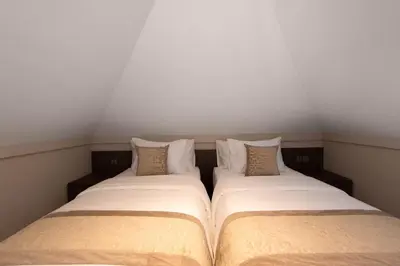 two beds sitting next to each other in a room at Baliris Home Boutique Legian in Seminyak