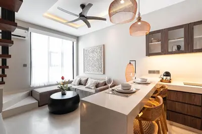 a kitchen and living room with a table and a couch at Baliris Home Boutique Legian in Seminyak