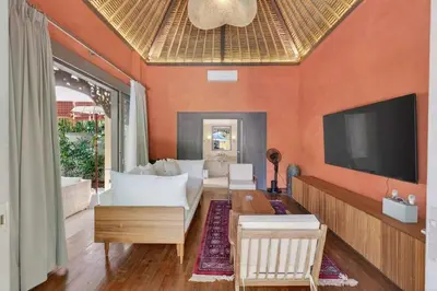 a living room with a couch and a tv at Tropical 3BR Villa Private Pool in Jimbaran in Jimbaran