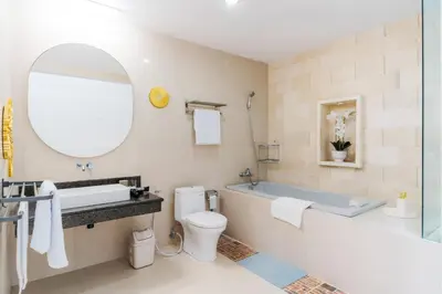 a bathroom with a tub and a toilet and a sink at Seminyak Luxe Villa Near Beach, Breakfast Concierge in Seminyak