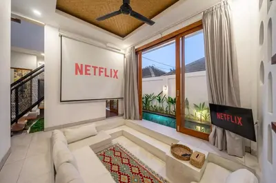 a living room with a netflix sign on the wall at 2BR Private tropical villas in Jimbaran in Jimbaran