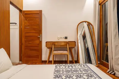 a bedroom with a desk and a bed and a table at 2BR Private tropical villas in Jimbaran in Jimbaran