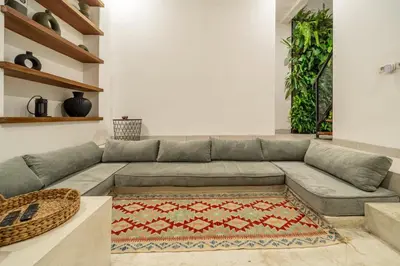 a living room with a gray couch and a rug at 2BR Private tropical villas in Jimbaran in Jimbaran