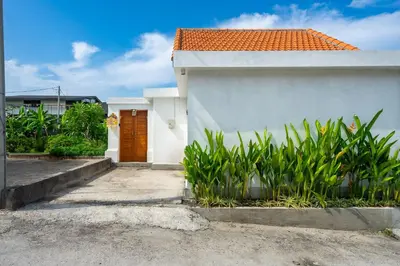 a white house with an orange roof at Modern 2BR Umalas Villa with Private Pool & Garden in Kerobokan