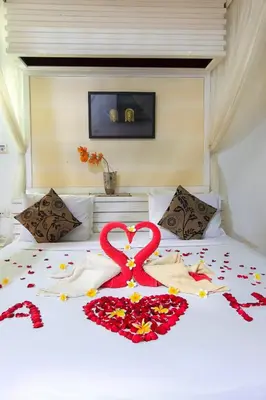 a bed with a heart made out of flowers on it at 1 Bed Room Villa in Kuta Central in Kuta