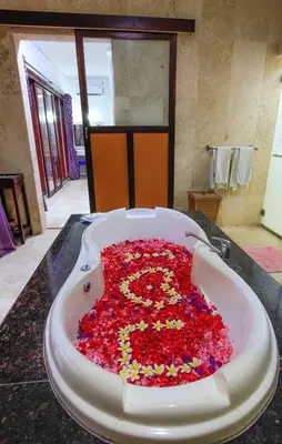 a bath tub filled with red flowers on a counter at 1 Bed Room Villa in Kuta Central in Kuta