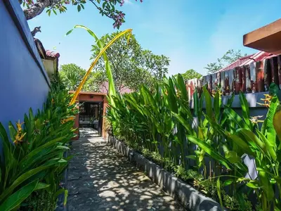 a path through a garden with plants at 1 Bed Room Villa in Kuta Central in Kuta