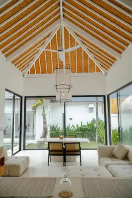 a living room with a table and a couch at Adhya Villa by GenuineHost in Kerobokan