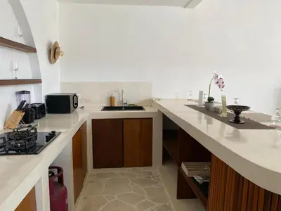 a kitchen with a sink and a counter top at Adhya Villa by GenuineHost in Kerobokan