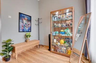 a room with a display cabinet filled with toys at Cozy 2BR Villa Taman Seminyak Suite 05 in Seminyak Bali in Seminyak